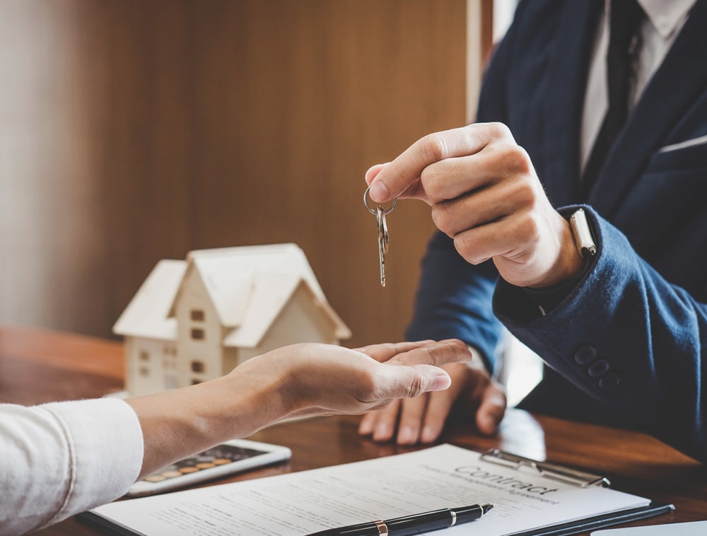 a man sitting at a table using a laptop
